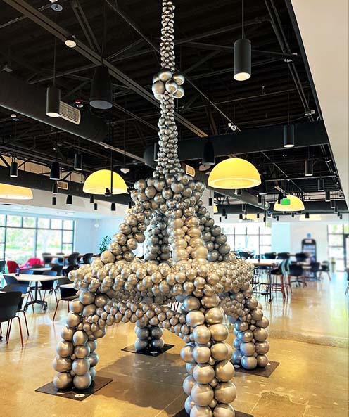 An 20 foot tall silver balloon sculpture of the Eiffel Tower to celebrate Bastille Day 2022